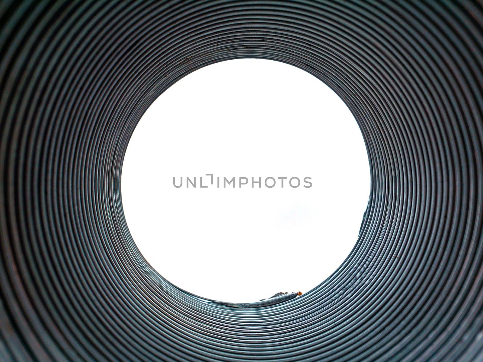 The texture of the metal corrugated ventilation pipe. Metal corrugation texture. Ventilation pipe. Hood. Embossed metal. Iron. Air conditioning duct. Intake hood air duct. Look into the pipe.