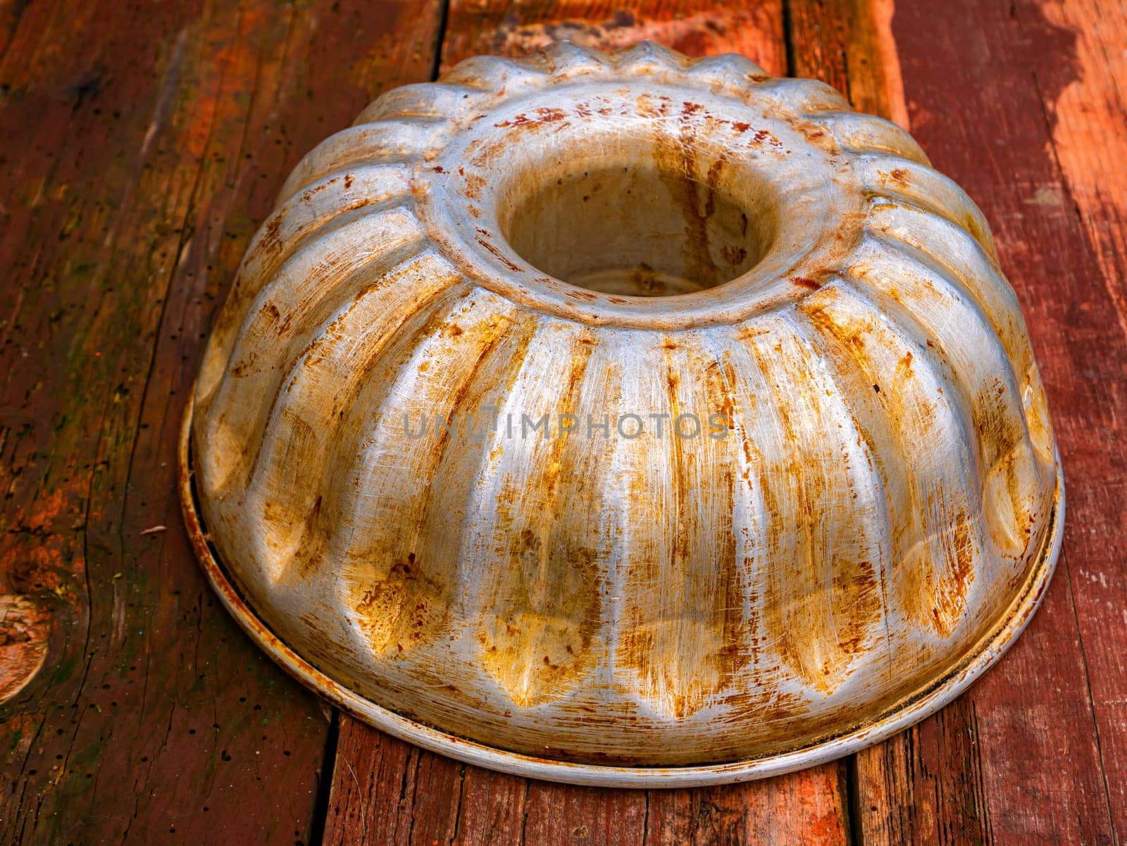 Aluminum bakeware for baking in the oven. Aluminum baking dish made of flour dough. Wooden kitchen table. Home kitchen. Bakers tool. Cook equipment. Cooking utensils. Cooking a flour dish.