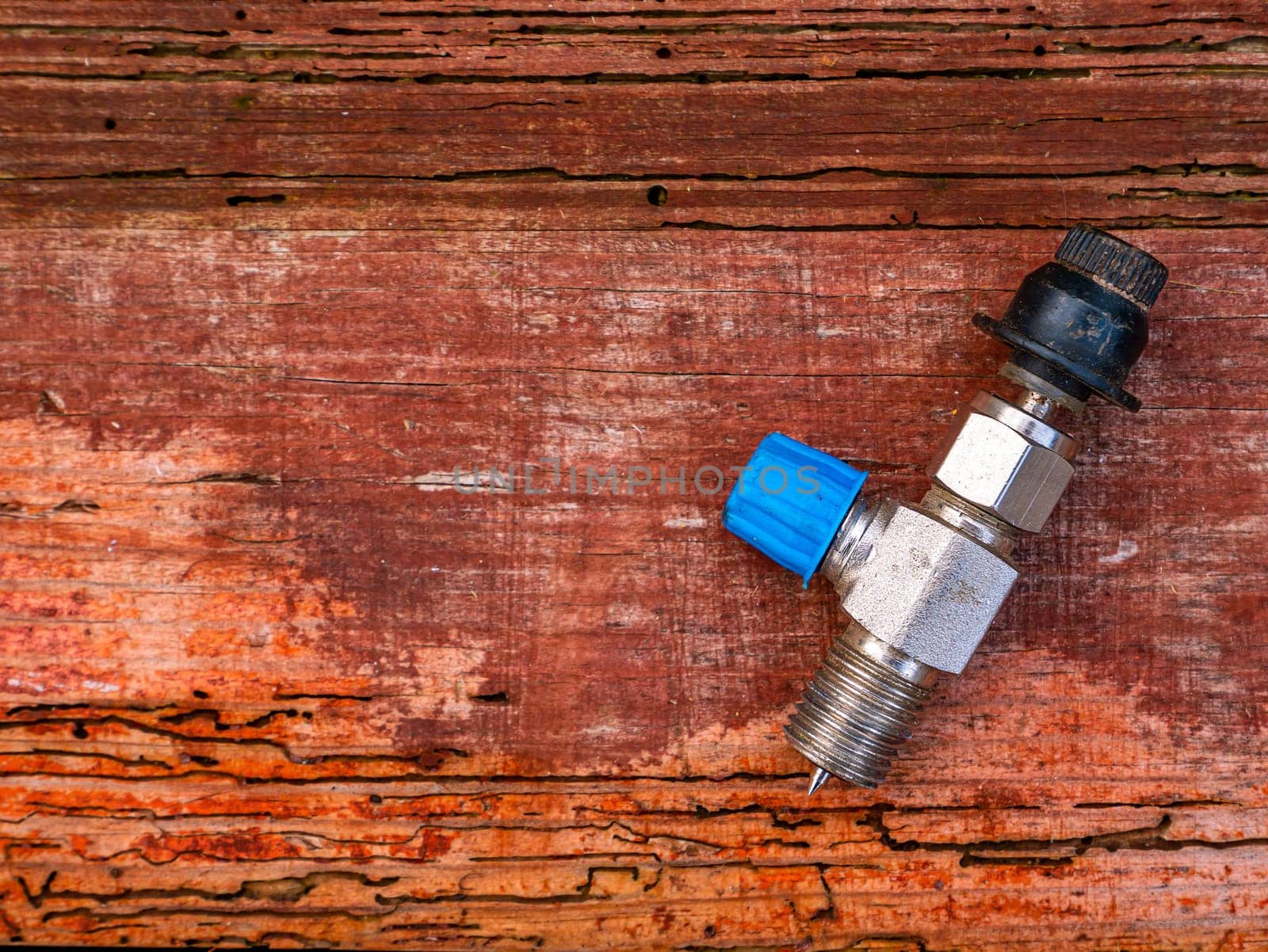 Freon cylinder needle valve for refrigerator repair. Needle valve for gas cylinder. Filling the refrigerator with freon. Filling the air conditioner with freon. Air conditioner repair. Work tool.