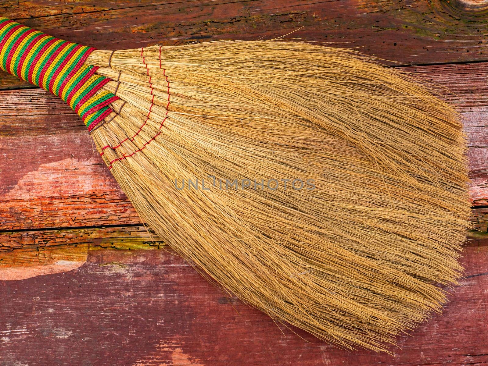 Wicker broom made of sorghum for indoor sweeping. Broom for sweeping the floor. House cleaning. Cleaning of office premises. Cleanliness and tidiness. Cleaning of the territory. Tool.