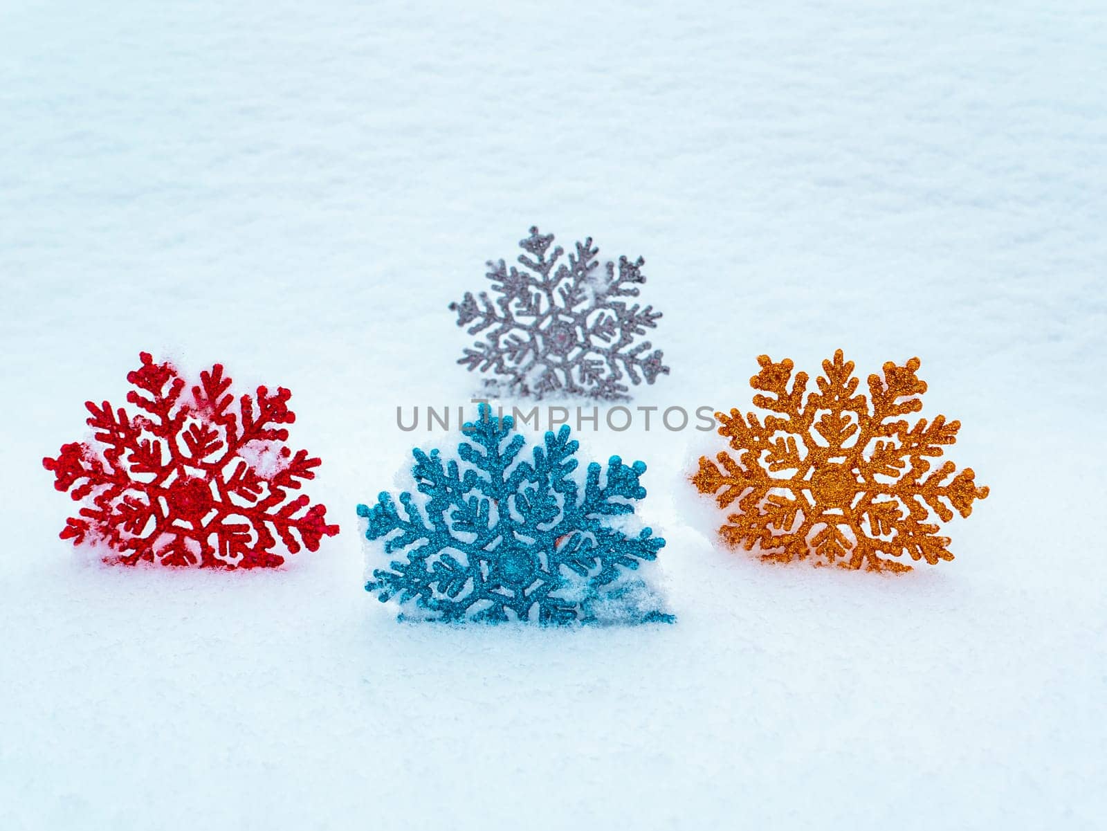 Christmas tree toys colored snowflakes on white snow. Christmas holidays. New Year. Loose winter snow. New Years holidays. Winter vacation. Place for text. Greeting card. White background.