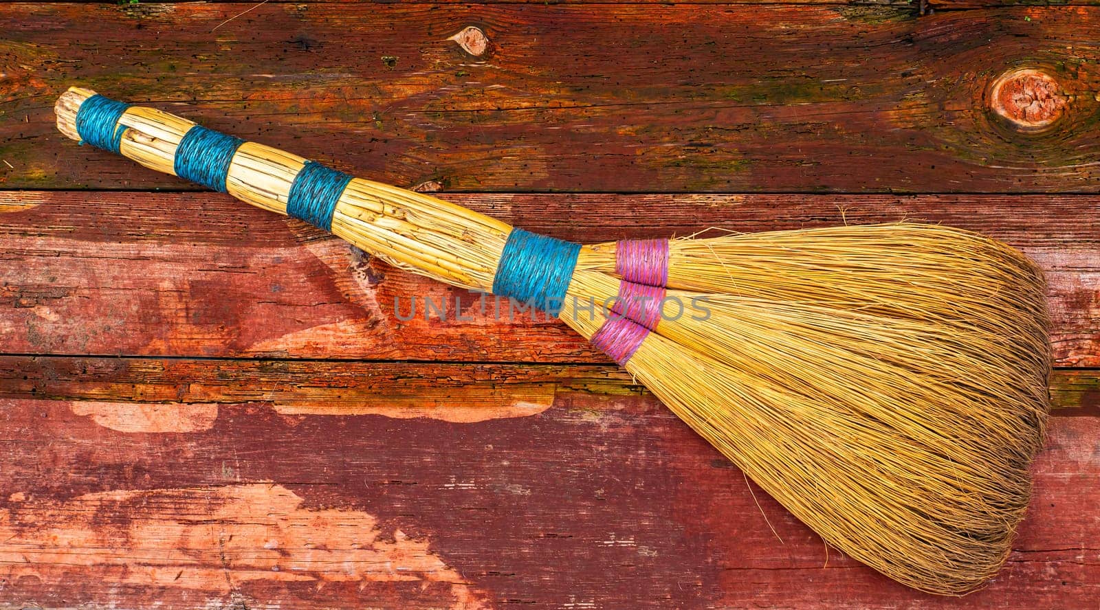 Wicker broom made of sorghum for indoor sweeping. Broom for sweeping the floor. House cleaning. Cleaning of office premises. Cleanliness and tidiness. Cleaning of the territory. Tool.