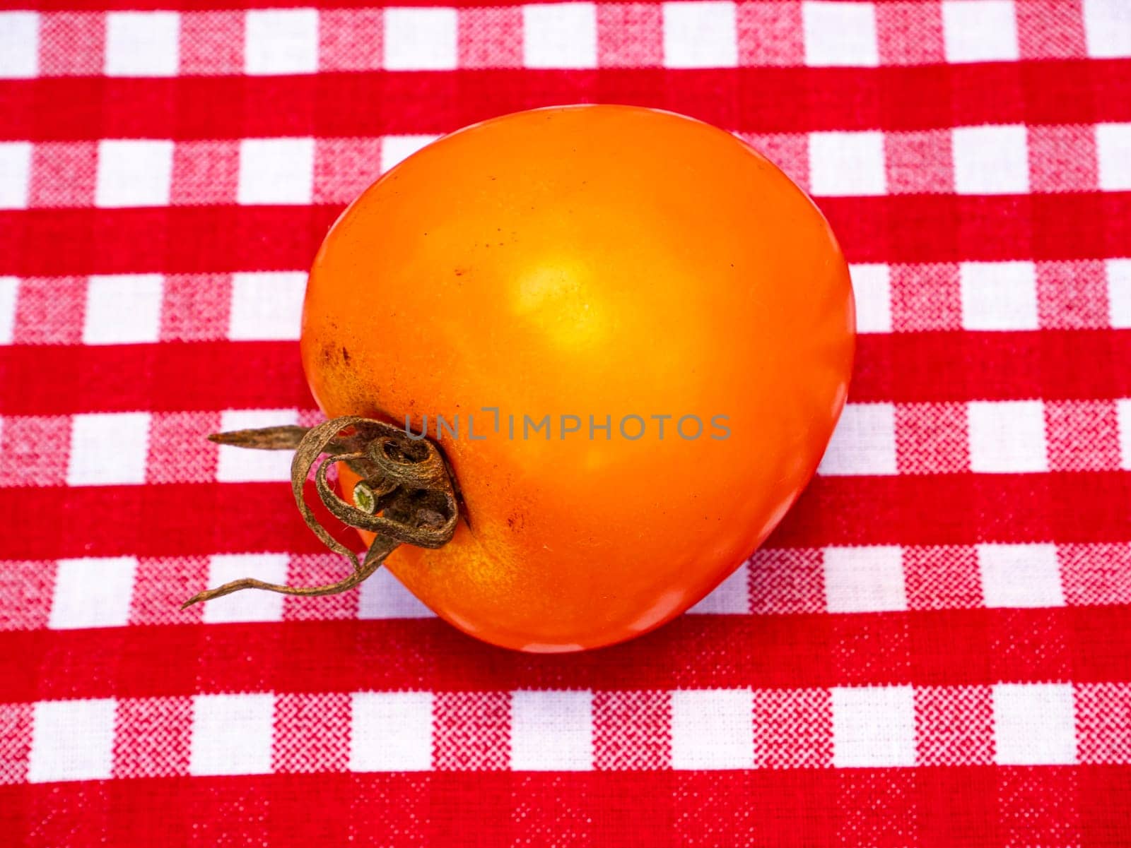 Yellow tomato vegetables on the kitchen table. Food photo. Harvesting tomato. Advertising photo of a shop window of a vegetable store. Agriculture. Farming activities. Place for text.