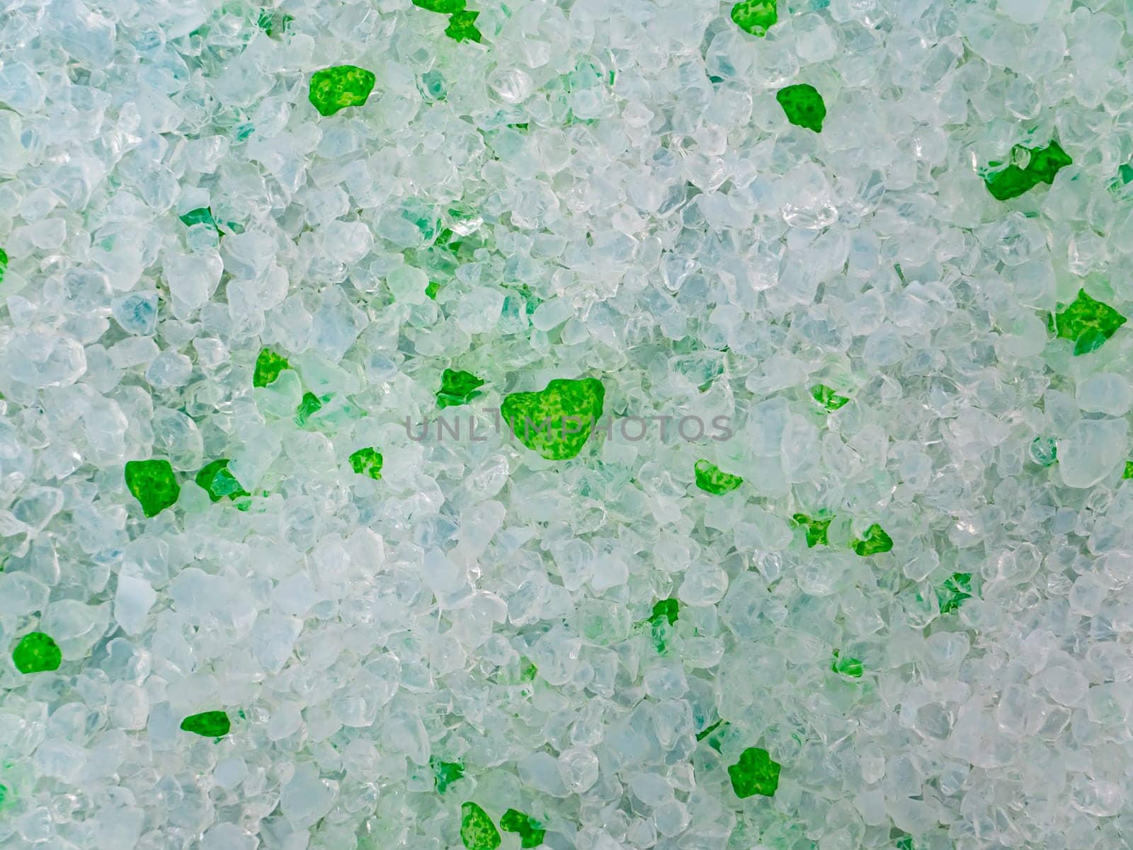 Texture of white and green crystalline granules. Background image. Template with place for text. Cat toilet.