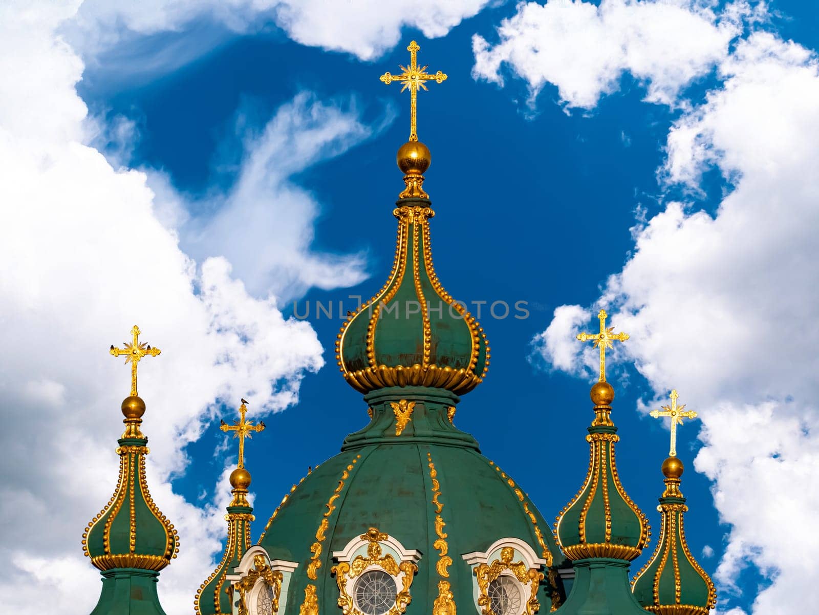 Domes with a cross of a Christian church. Christian cross. Religion and culture. Orthodox church. Blue sky. White clouds. Merry Christmas. Easter holidays. Background image.