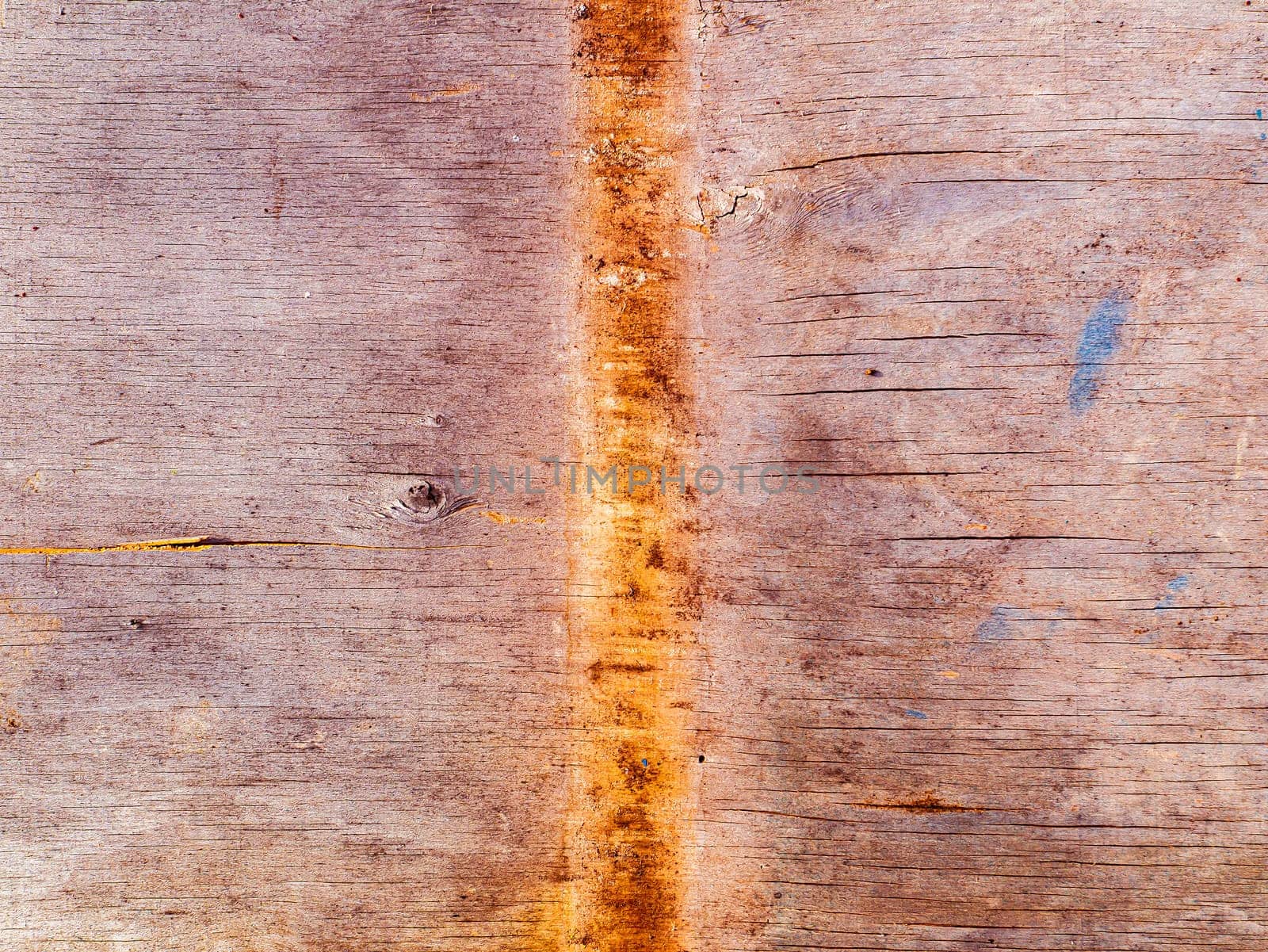 Faded texture of a wooden plank surface with rusty spots. Rusty metal stains on a wooden board. Bough of a tree. Aging process. Background image. Place for text. Cracks. Poster.
