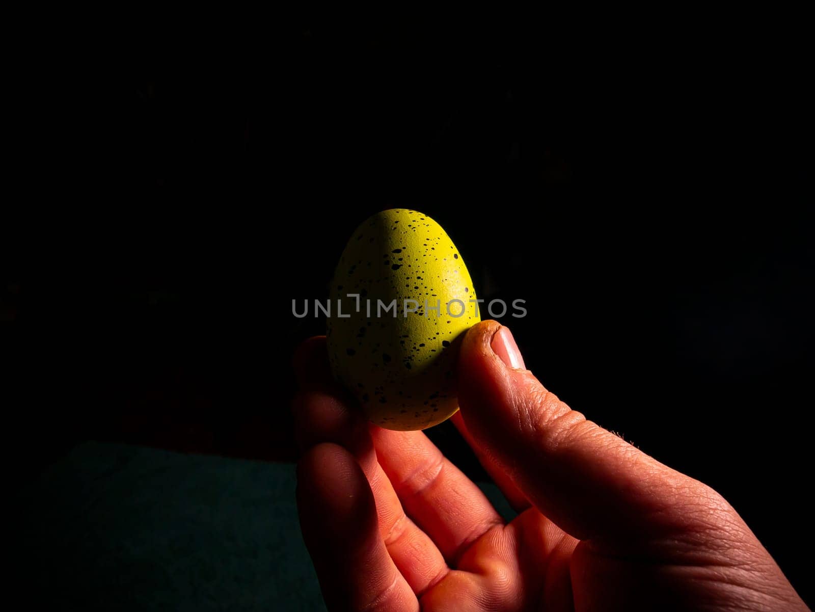 Easter chicken eggs in hand on a black background. Easter chicken eggs. Christ is risen. Christian religion. Religious holiday. Palms of human hands. Christian culture. Religious prayer. Tradition.