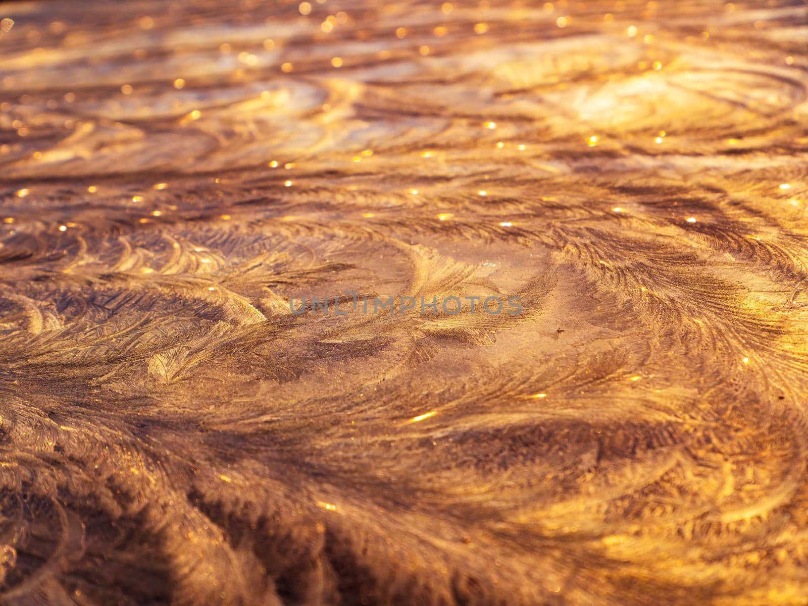 The texture of patterns of frost on the glass in winter. Frosty pattern on a glass window. White snow. Frozen water. Crystals of ice. Winter season. Weather. Weather forecast. Background image.