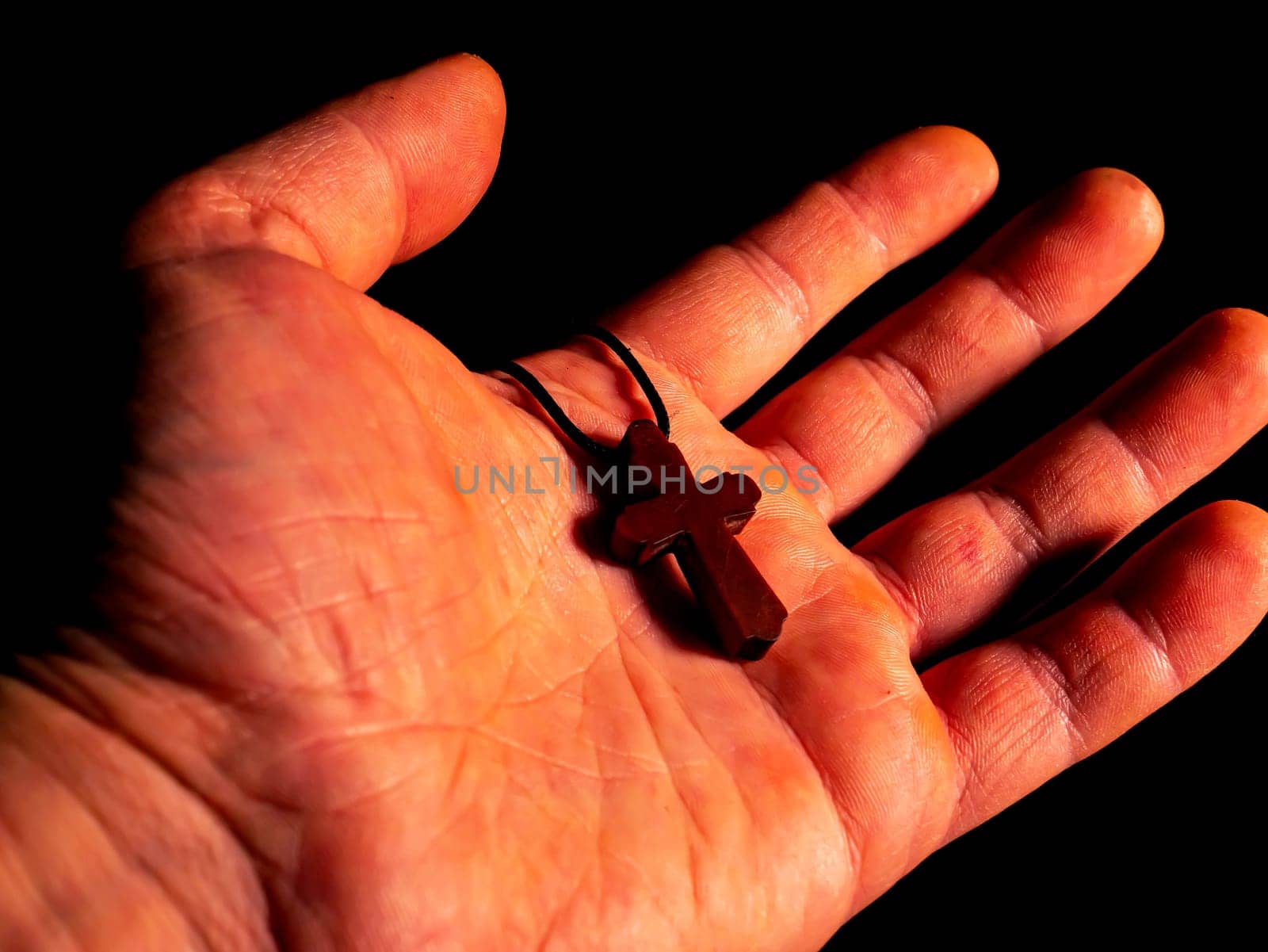 Christian pectoral cross on a mans palm. Christian pectoral cross. Orthodox religion. Man's hand. Faith in God. Pray to God. Religious people. Church amulet. Personal amulet. Sacred sign.