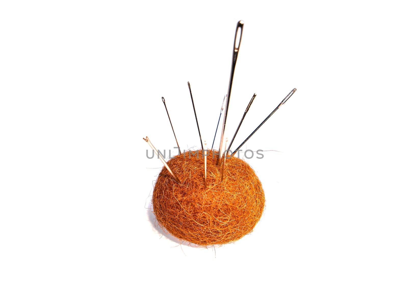 Soft fabric pad for sewing metal needles on a white background. A pillow with photknuts with needles. Cutting and sewing clothes. Clothing repair. Hand tool. White background.
