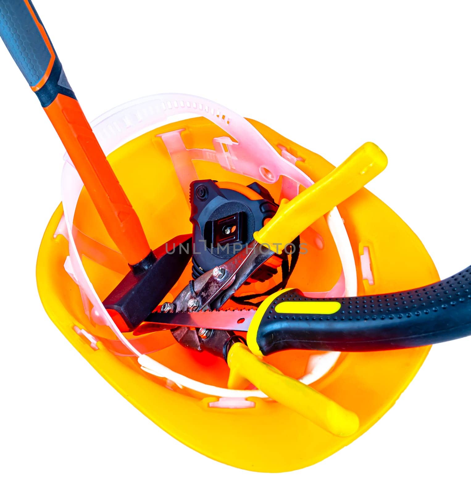 Work tool inside an orange safety helmet on a white background. Working tool. Plastic protective helmet for the worker. Worker tool. Hammer and pliers. Construction and repair. Background.