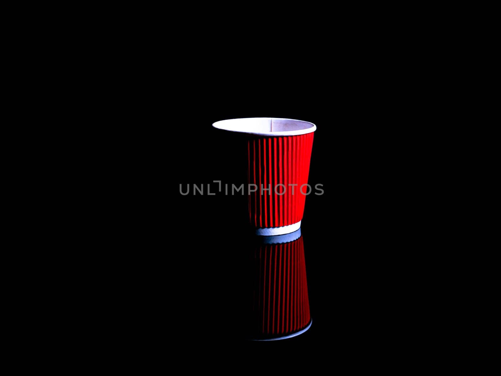 Disposable cardboard cups for coffee on a black background. Cardboard glass. Disposable tableware. Coffee drinks. Red color. Paper dishes for drinks. Black background. Darkness.