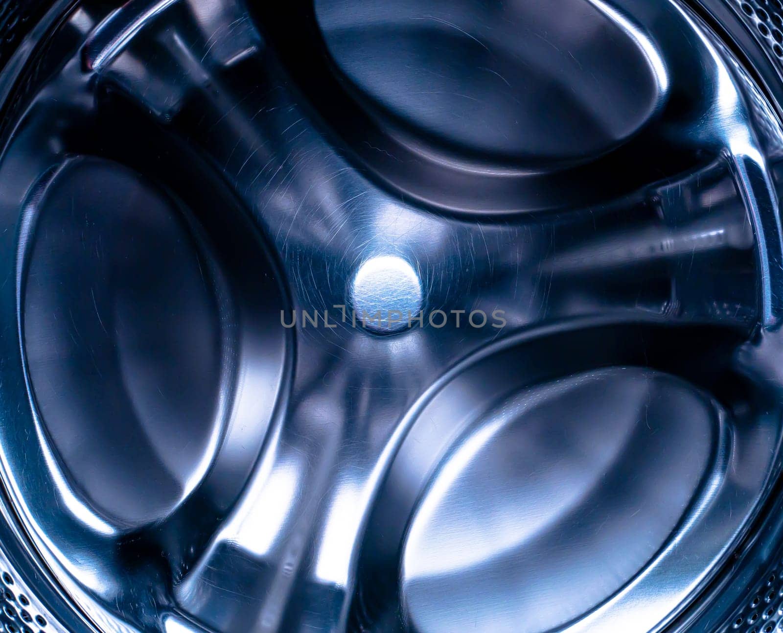Metal drum of the washing machine made of stainless steel. Stainless steel tank. Washing machine repair service. Household appliances repair workshop. Mechanic repairman. Home wash.