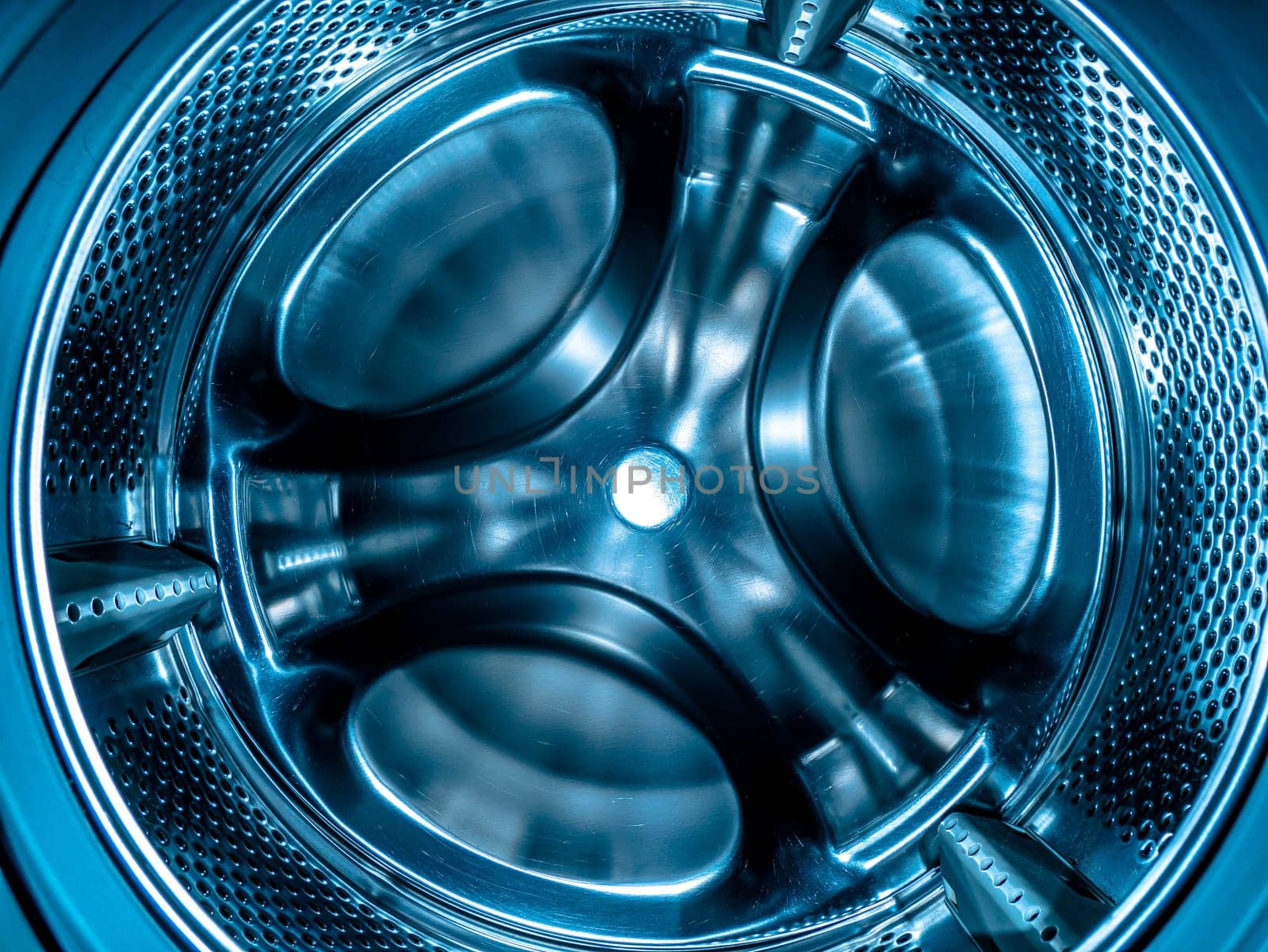 Metal drum of the washing machine made of stainless steel. Stainless steel tank. Washing machine repair service. Household appliances repair workshop. Mechanic repairman. Home wash.