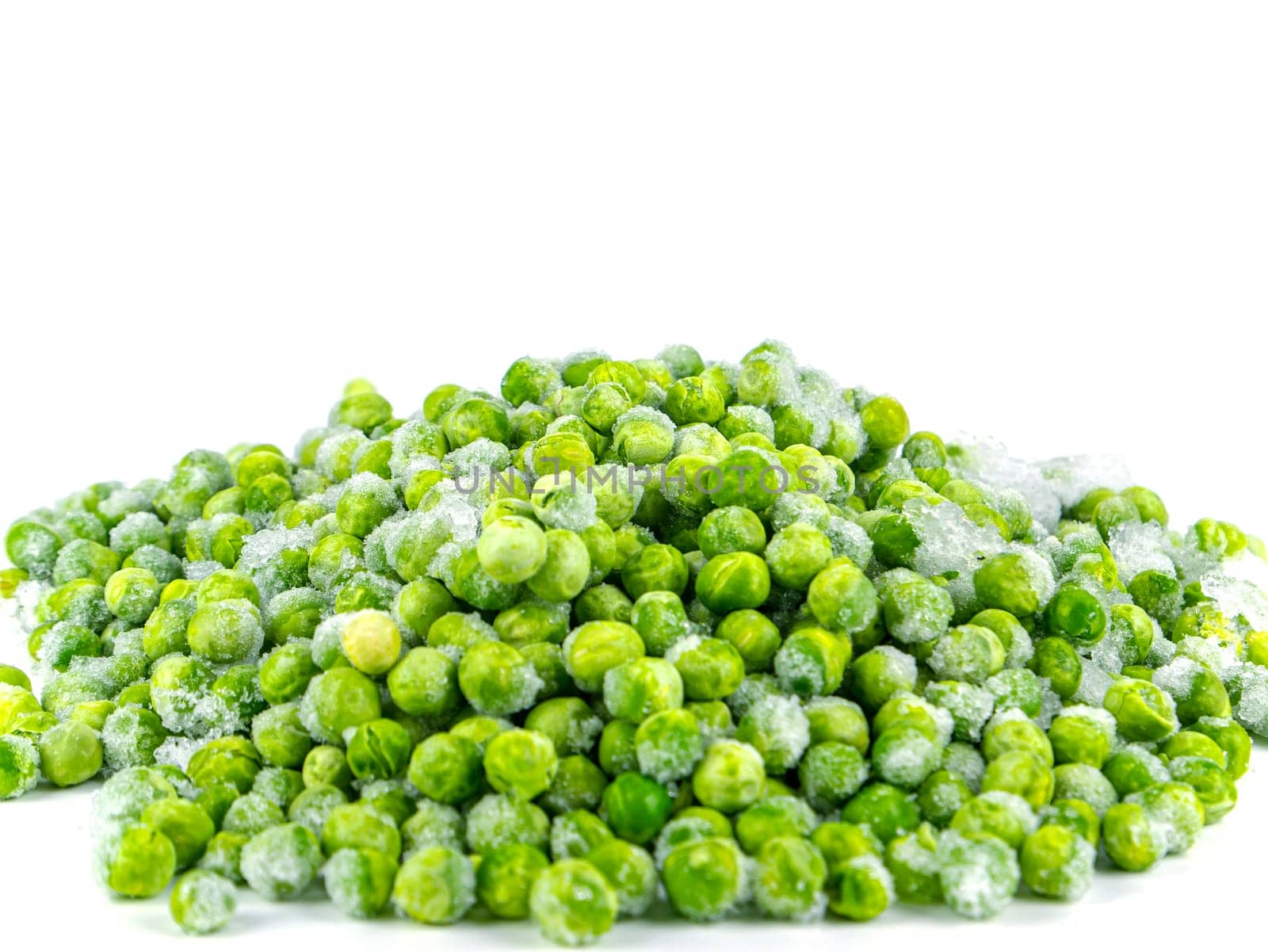 Frozen green peas vegetable on a white plate. Frozen vegetables. Green peas. Food in the refrigerator. Food storage. Vegetarian food. Harvest storage. White background.