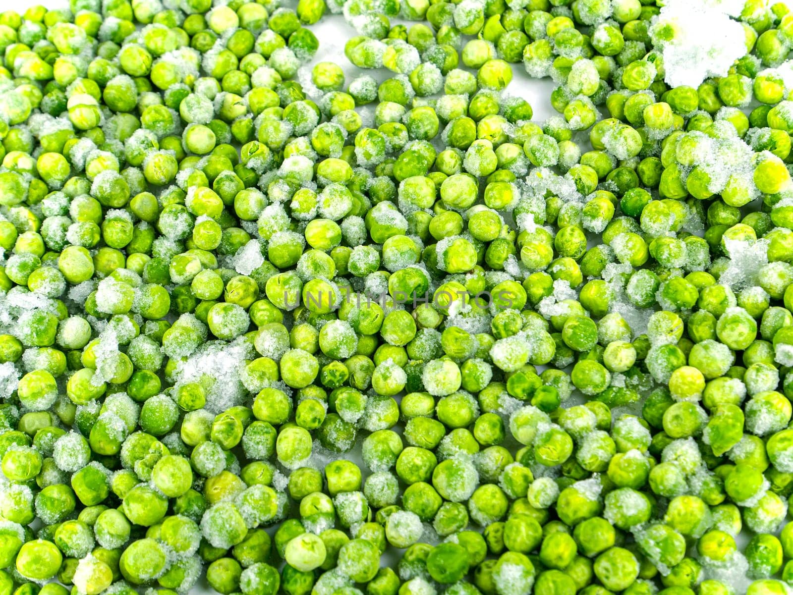 Frozen green peas vegetable on a white plate. Frozen vegetables. Green peas. Food in the refrigerator. Food storage. Vegetarian food. Harvest storage. White background.