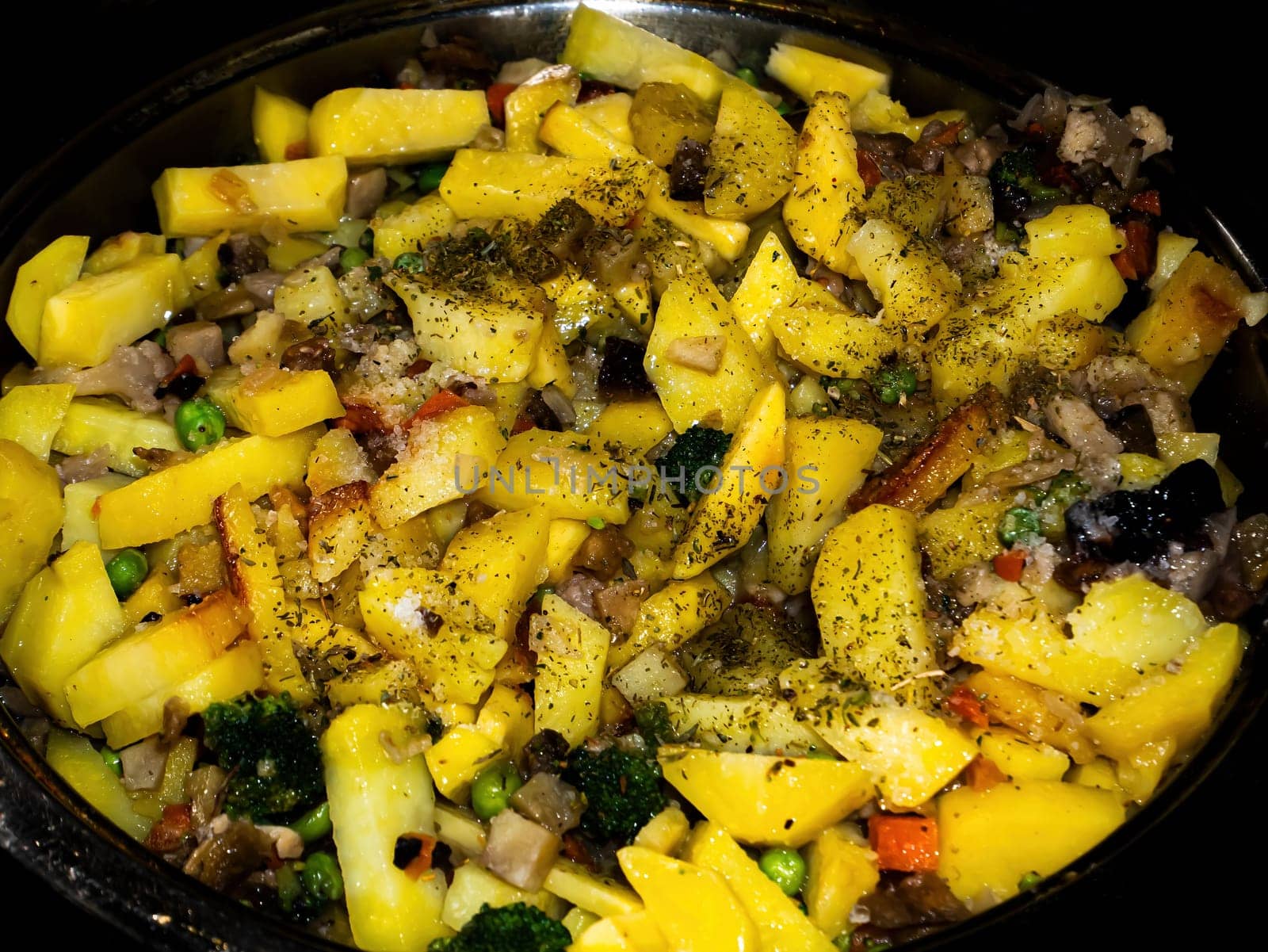 Fried potatoes with vegetables in a pan. Cooking vegetables. Fry potatoes. Frying pan kitchen utensils. Home kitchen. Menu of dishes. Fast food. Culinary recipe for the dish. Unhealthy food.