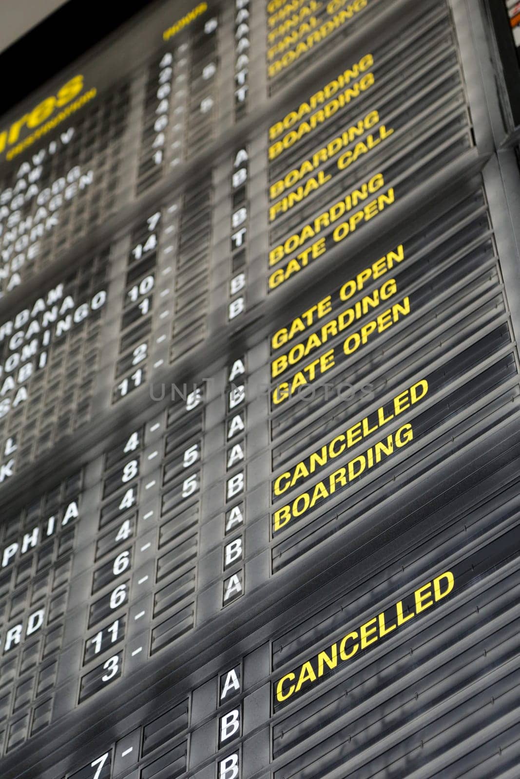 Airport departure board in terminal with flight information