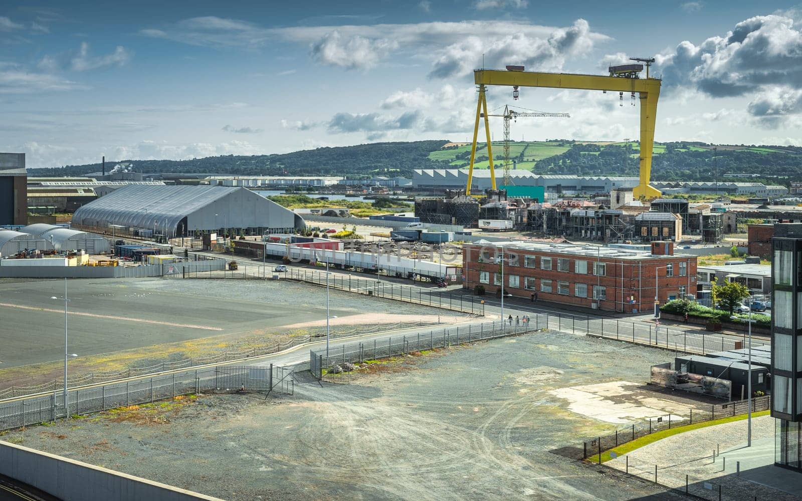 Elevated view on Belfast industrial quarters, harbour and docks with large yellow crane, UK, Northern Ireland