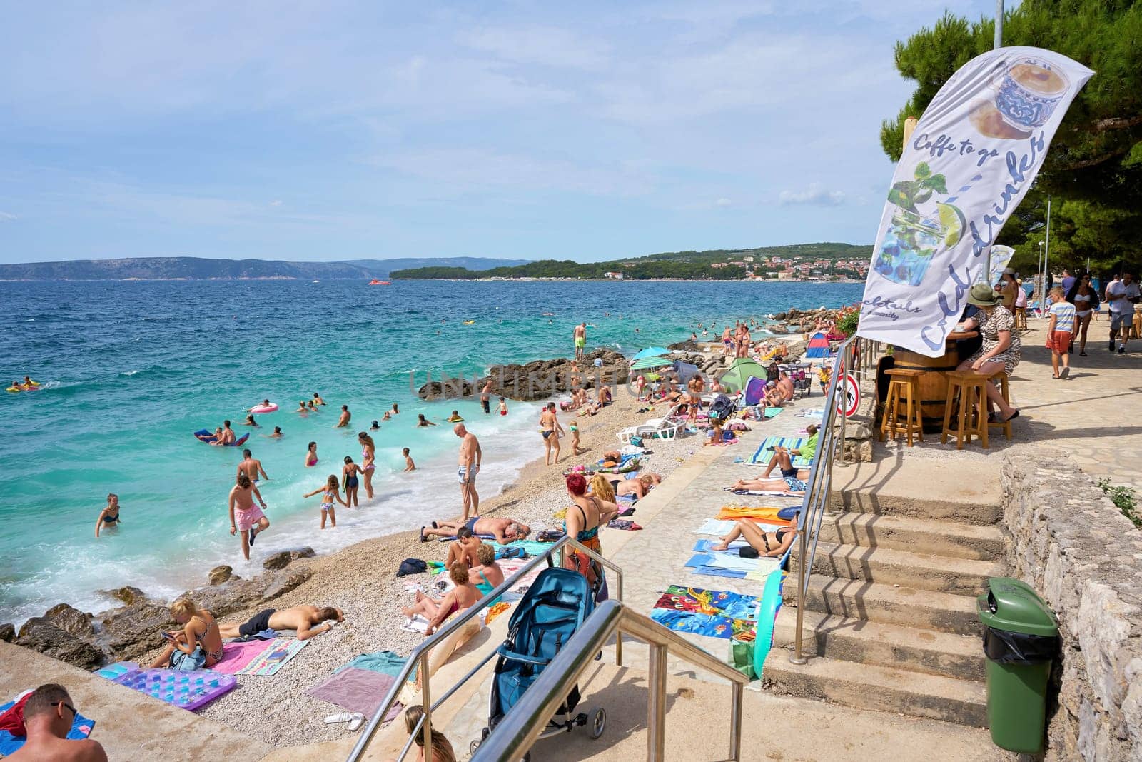 Holidaymakers bathing on the shore of the Adriatic Sea near the town of Krk on the island of the same name in Croatia