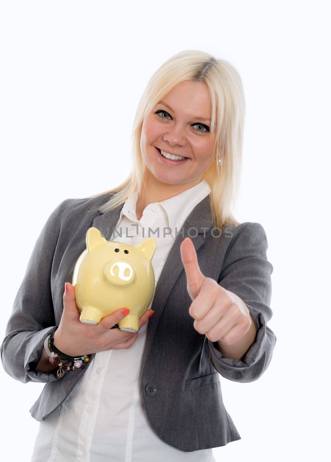 smiling blond young business woman with piggy bank and thumb up