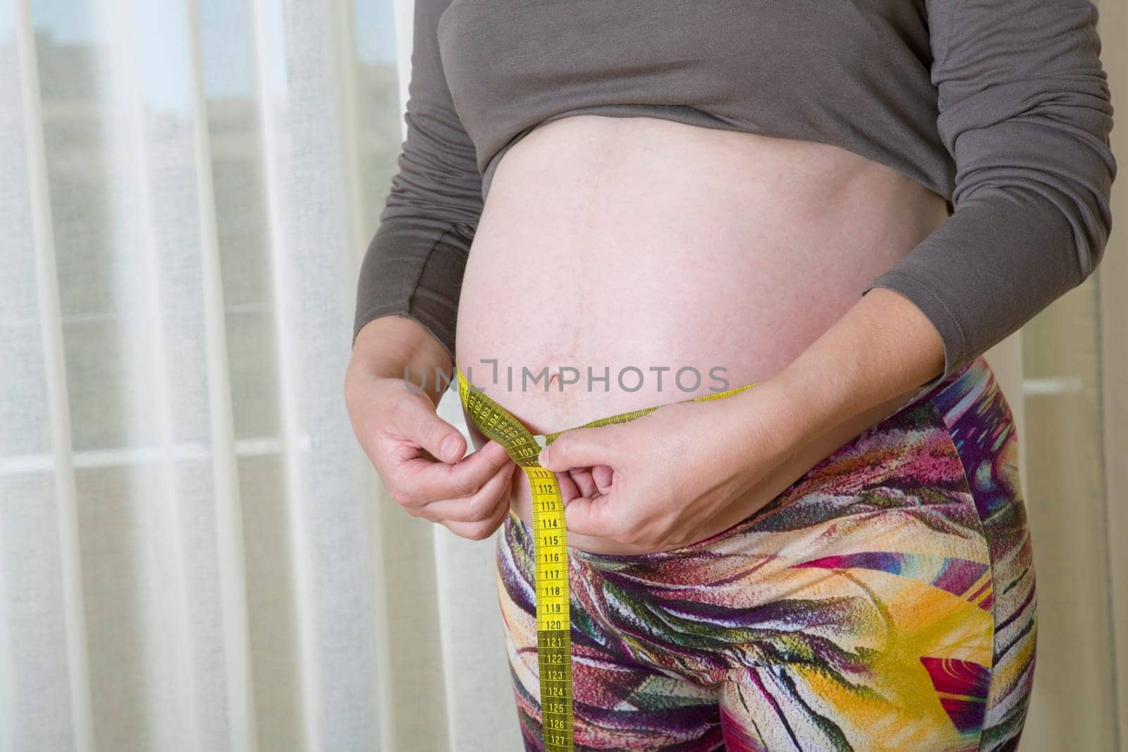 Closeup of pregnant woman at home