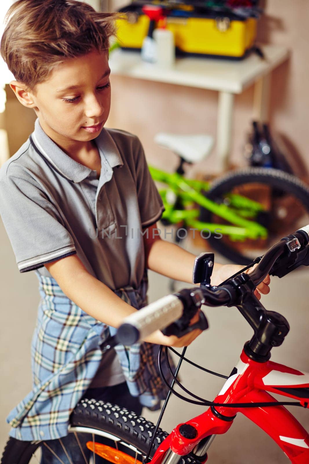 Adolescent boy looking at bicycle