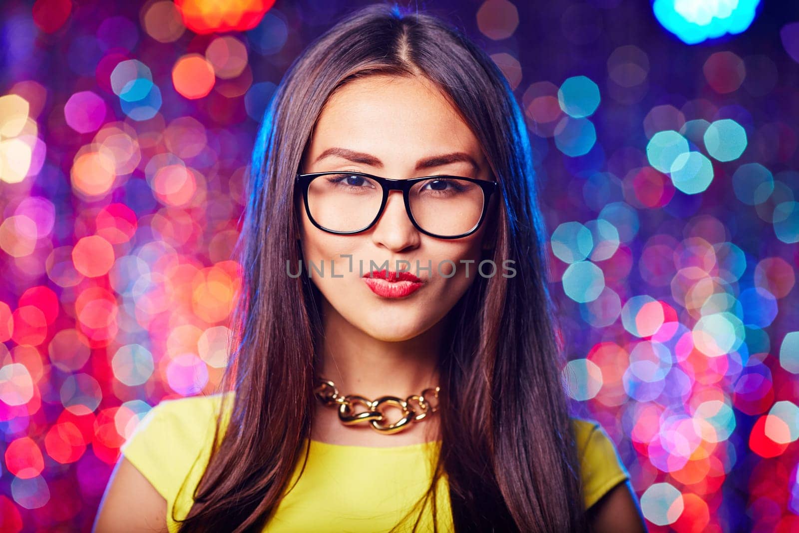 Asian brunette in eyeglasses looking at camera