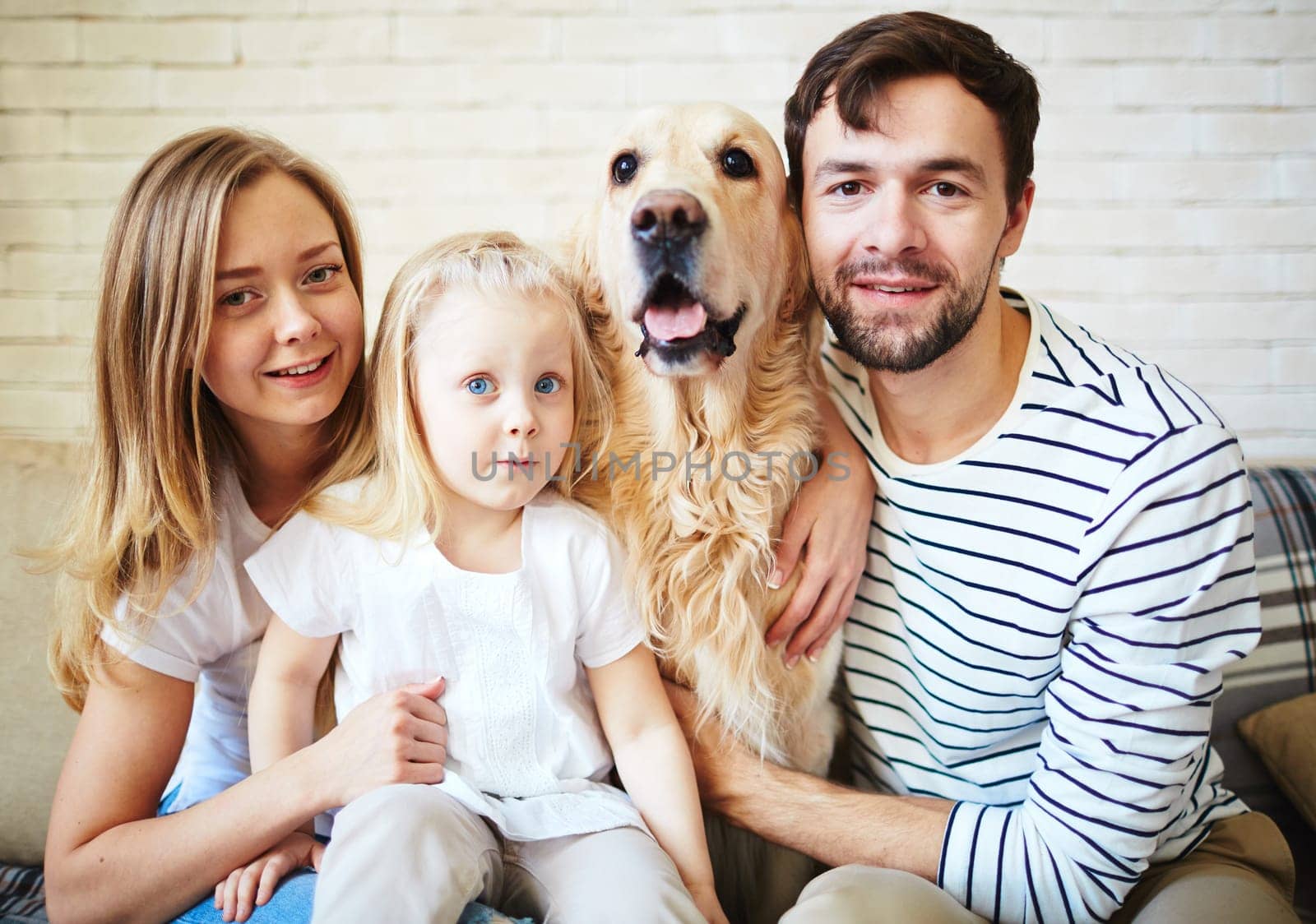 Parents, their daughter and dog spending weekend at home