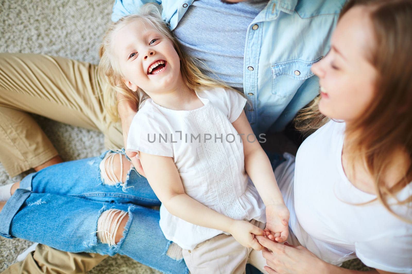 Ecstatic girl enjoying spending time with her parents