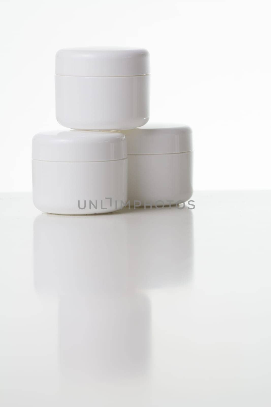 Three white cream cans