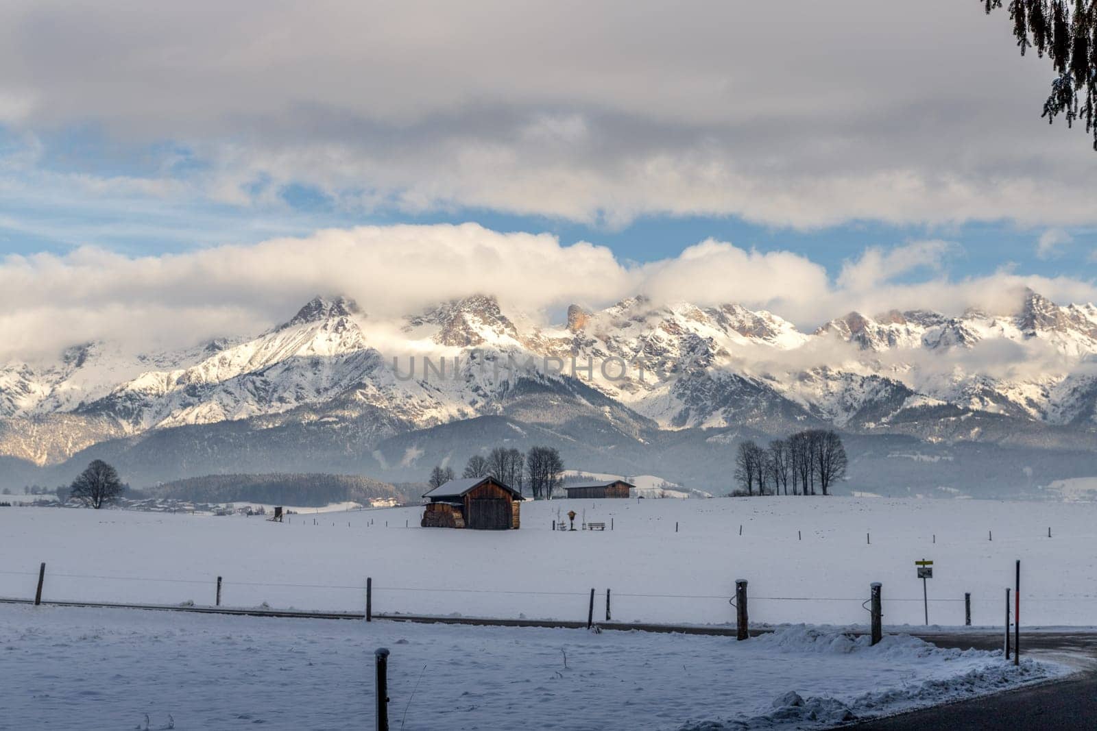Snowy mountains, meadow and a hut, landscape in Austria