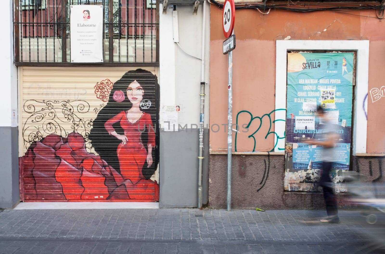 Seville, Spain - Sept 26th 2020: Man walking by narrow streets of Macarena neighborhood, Seville, Spain. Blurred motion shot
