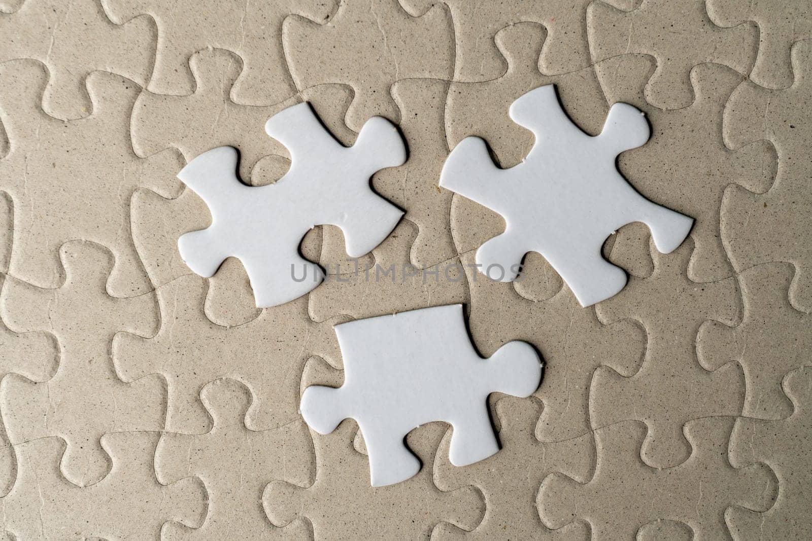 Three pieces of jigsaw puzzle on incomplete puzzle