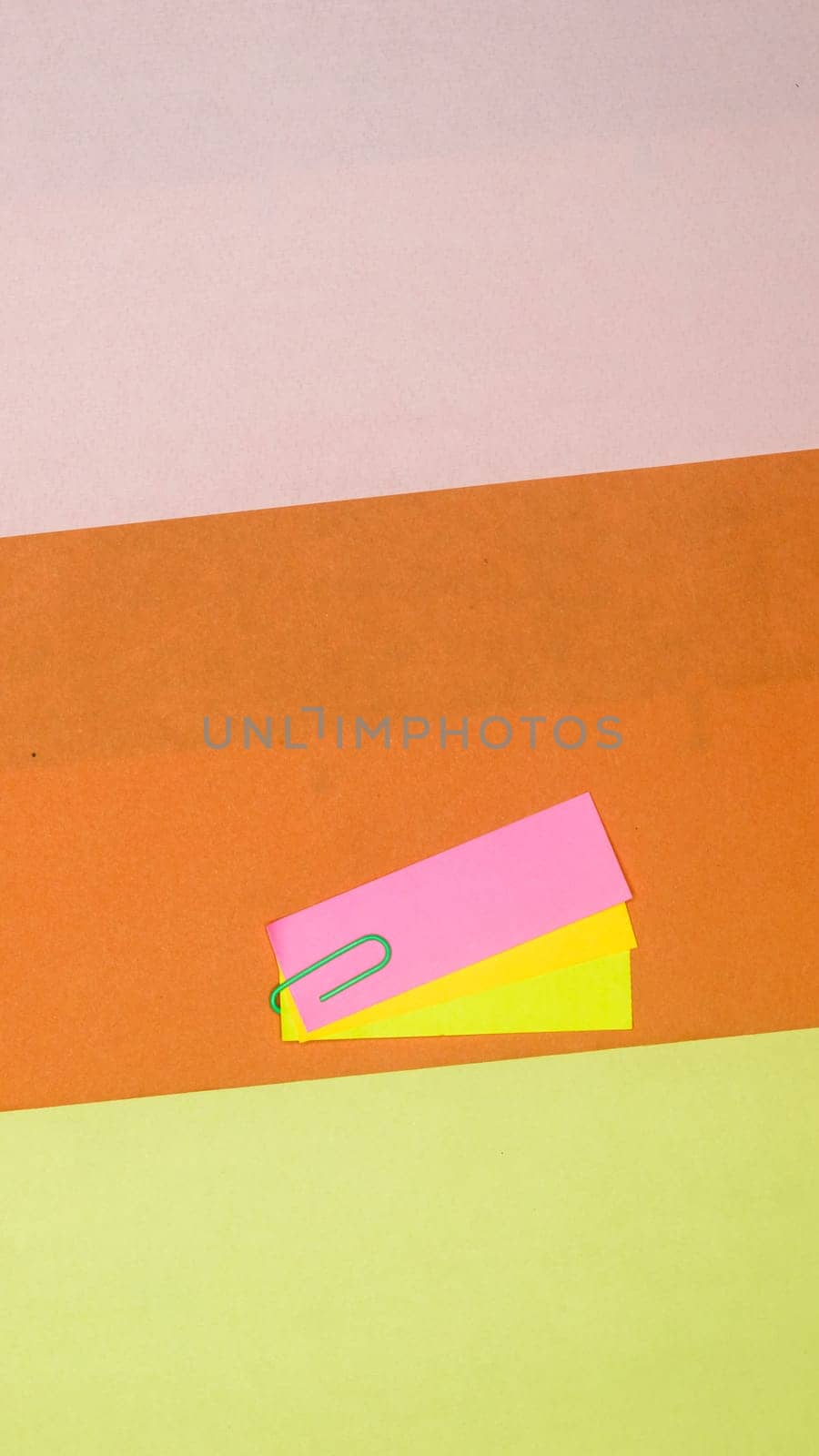 Paper clip Attachment on Kraft paper. Abstract background color art minimalist design. Vertical. Flat Lay.