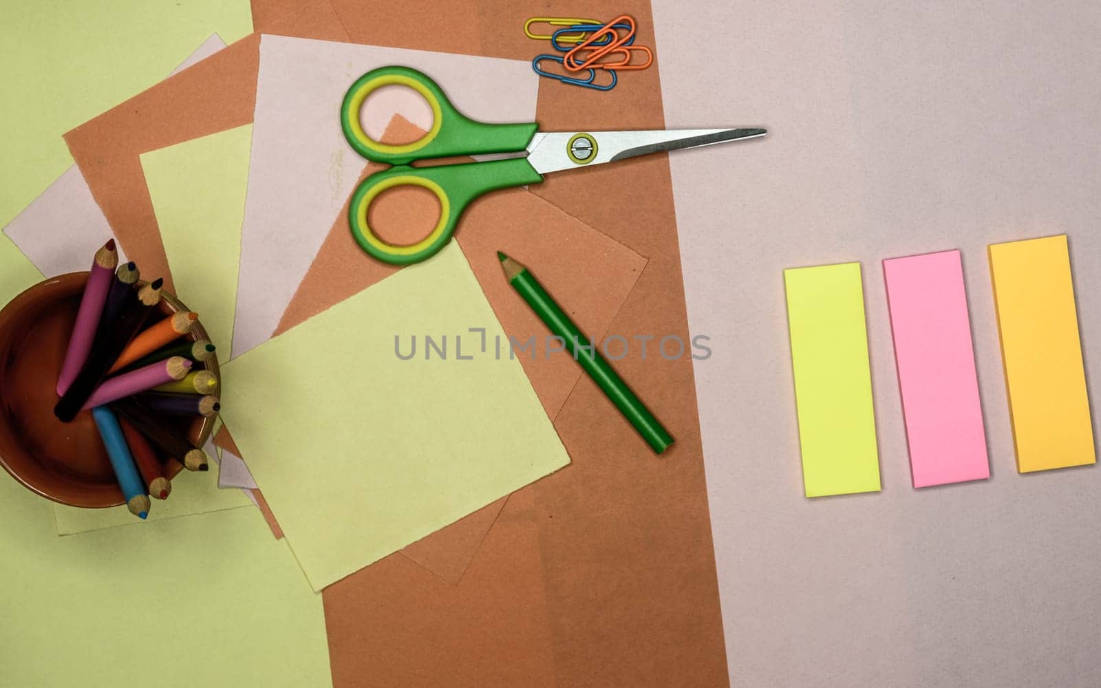 Set of tools for Scrapbook Artist and Paper Crafter. Colour paper, scissors, pencils, paint, and ruler on table. DIY Paper Crafts making creative background. Flat lay.