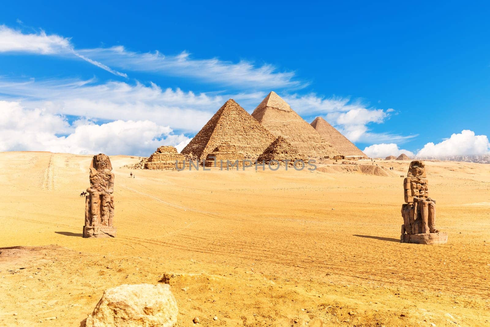 Pyramids of Egypt and The Colossi of Memnon in the desert of Giza.