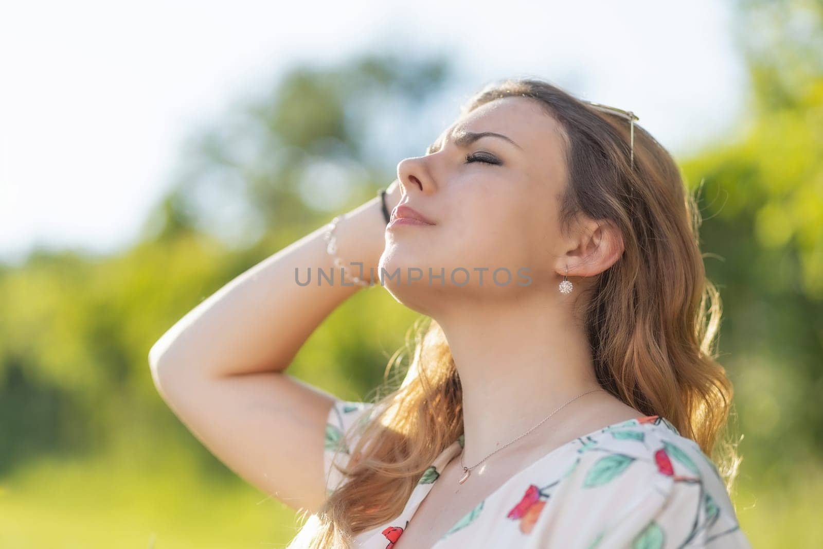 Side view of the face of sunbathing beautiful young woman. Horizontally.