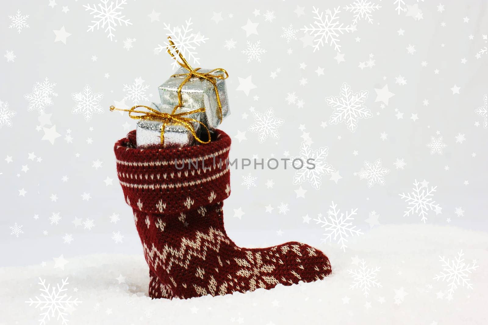 Christmas background with festive stocking full of gifts nestled in snow