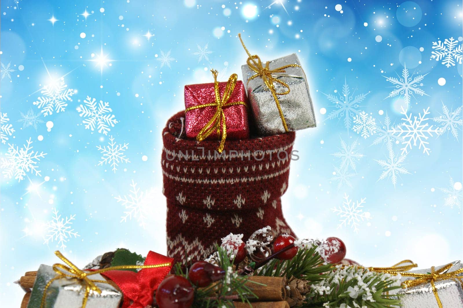 Christmas stocking full of gifts on a snowflake background