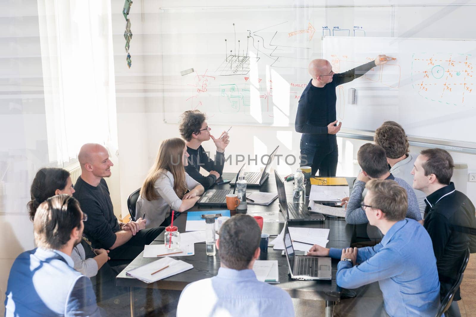 Relaxed informal IT business startup company meeting. Team leaders discussing and brainstorming new approaches and ideas with colleagues. Startup business and entrepreneurship concept.