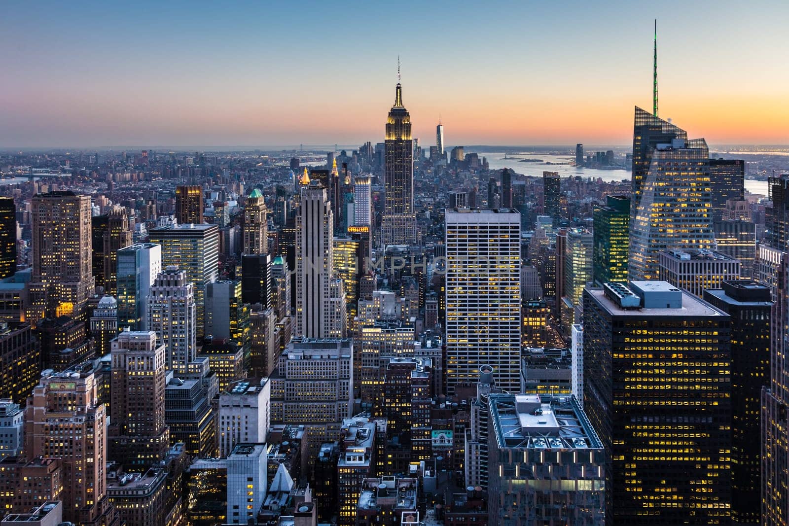 New York City. Manhattan downtown skyline with illuminated Empire State Building and skyscrapers at dusk. USA.