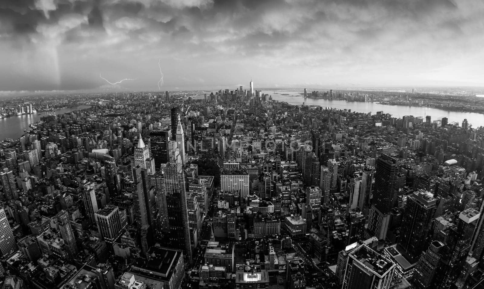 New York City skyline with Manhattan skyscrapers at dramatic vibrant after the storm sunset, USA. Black and white image.