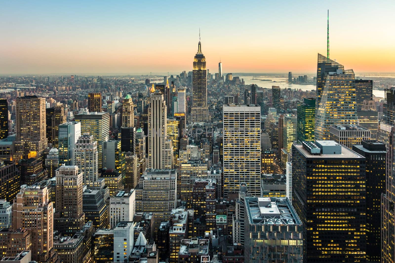 New York City. Manhattan downtown skyline with illuminated Empire State Building and skyscrapers at dusk. USA.