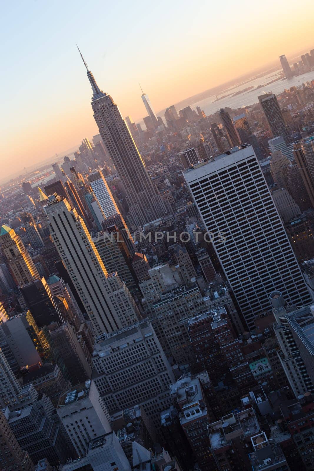 Golden sunset panoramic view of building and skyscrapers in Midtown and downtown skyline of lower Manhattan, New York City, USA.