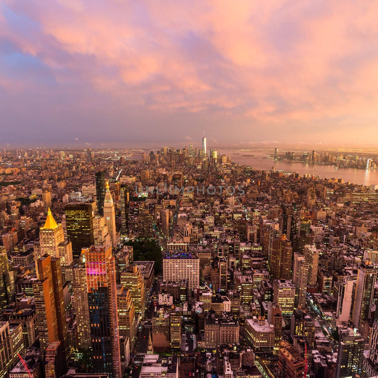 New York City skyline with Manhattan skyscrapers at dramatic vibrant after the storm sunset, USA. Rainbow can be seen in background over Brooklyn bridge.
