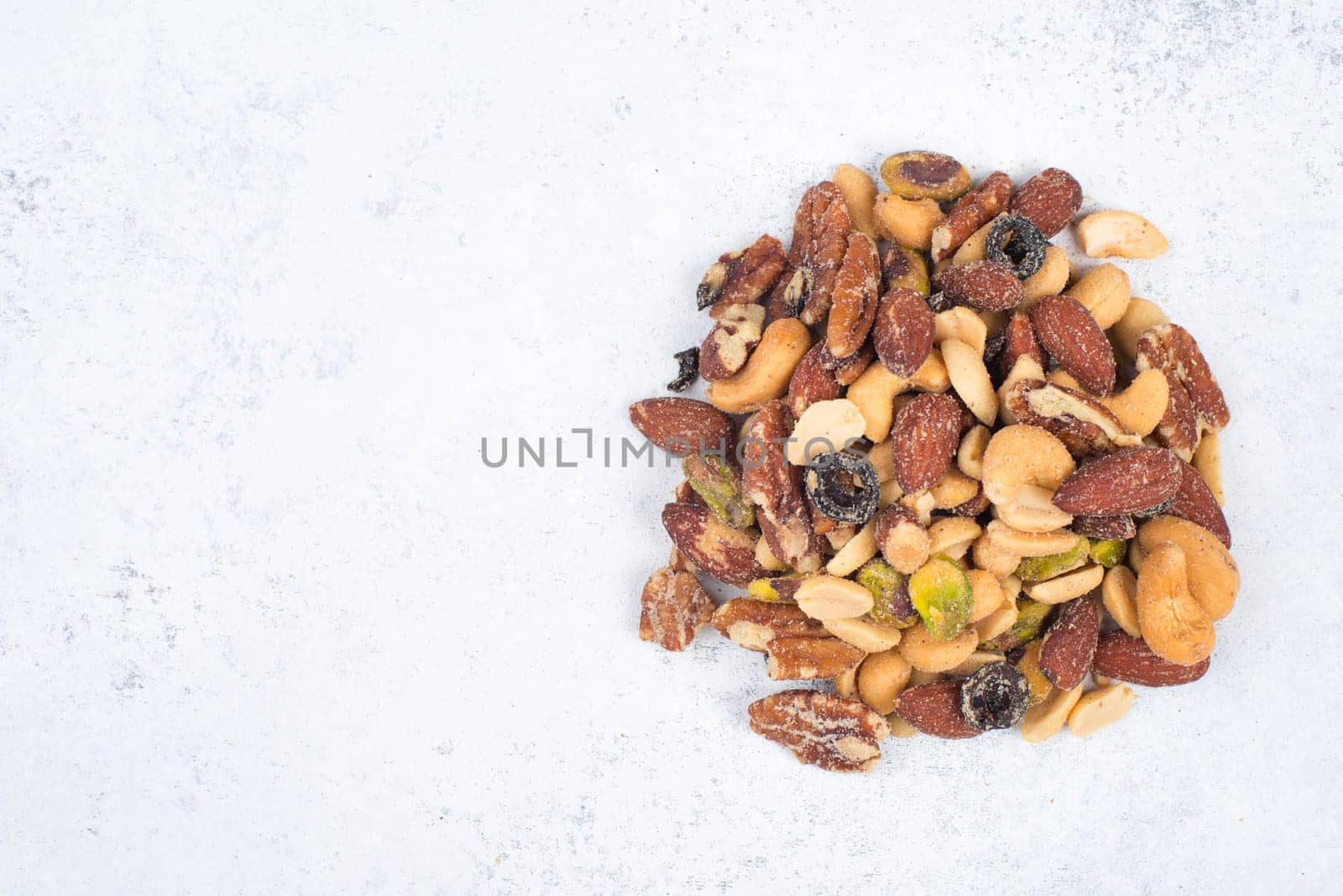 Mix of nuts and black olives isolated on a white background, spicy, salty food snack