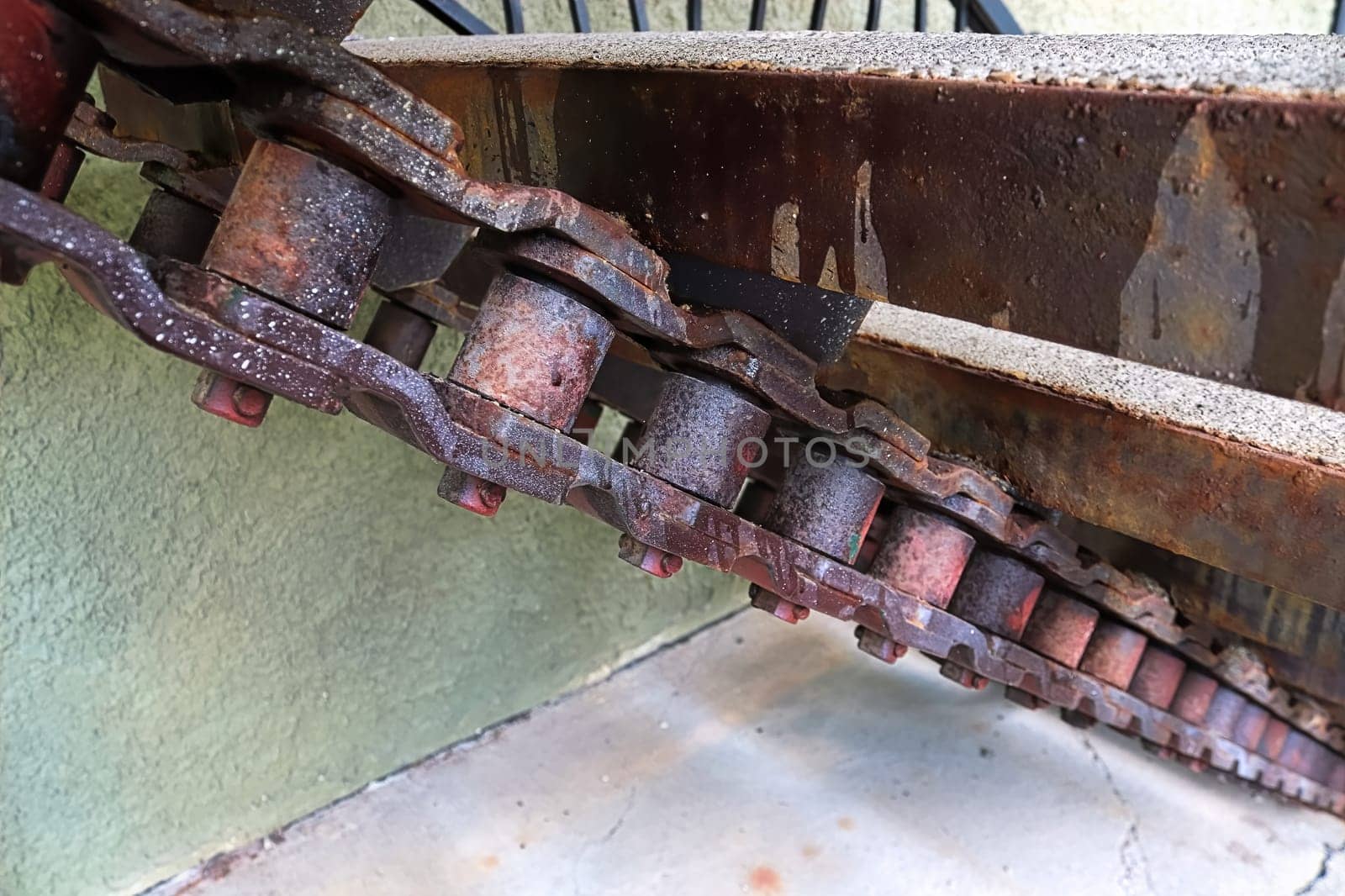 Closeup of large stairs made with large machinery chains.