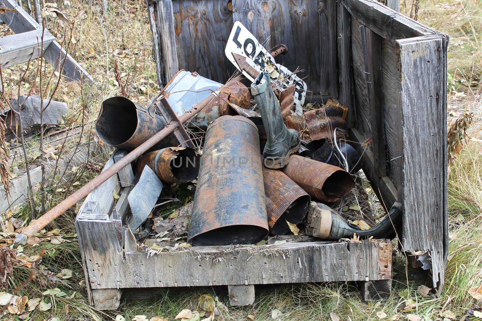 A pile of rusty metal garbage in a bin.