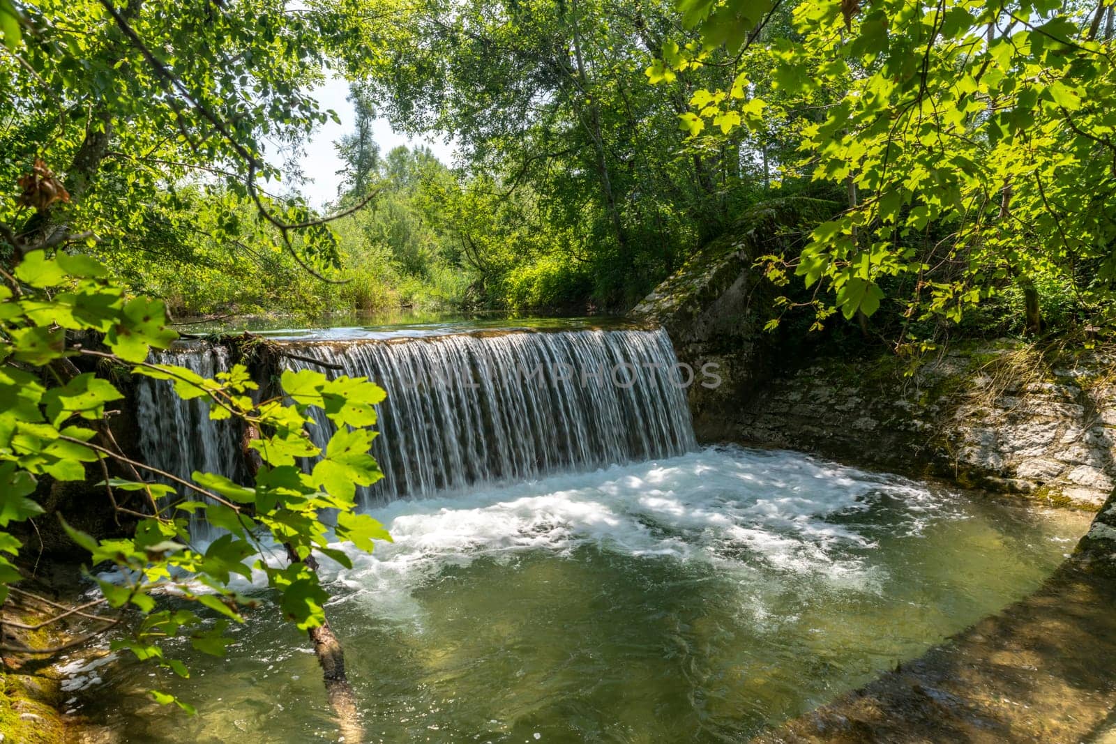 Waterfall at a barrage in the forest in the Bavarian Forest Chiemgau Germany
